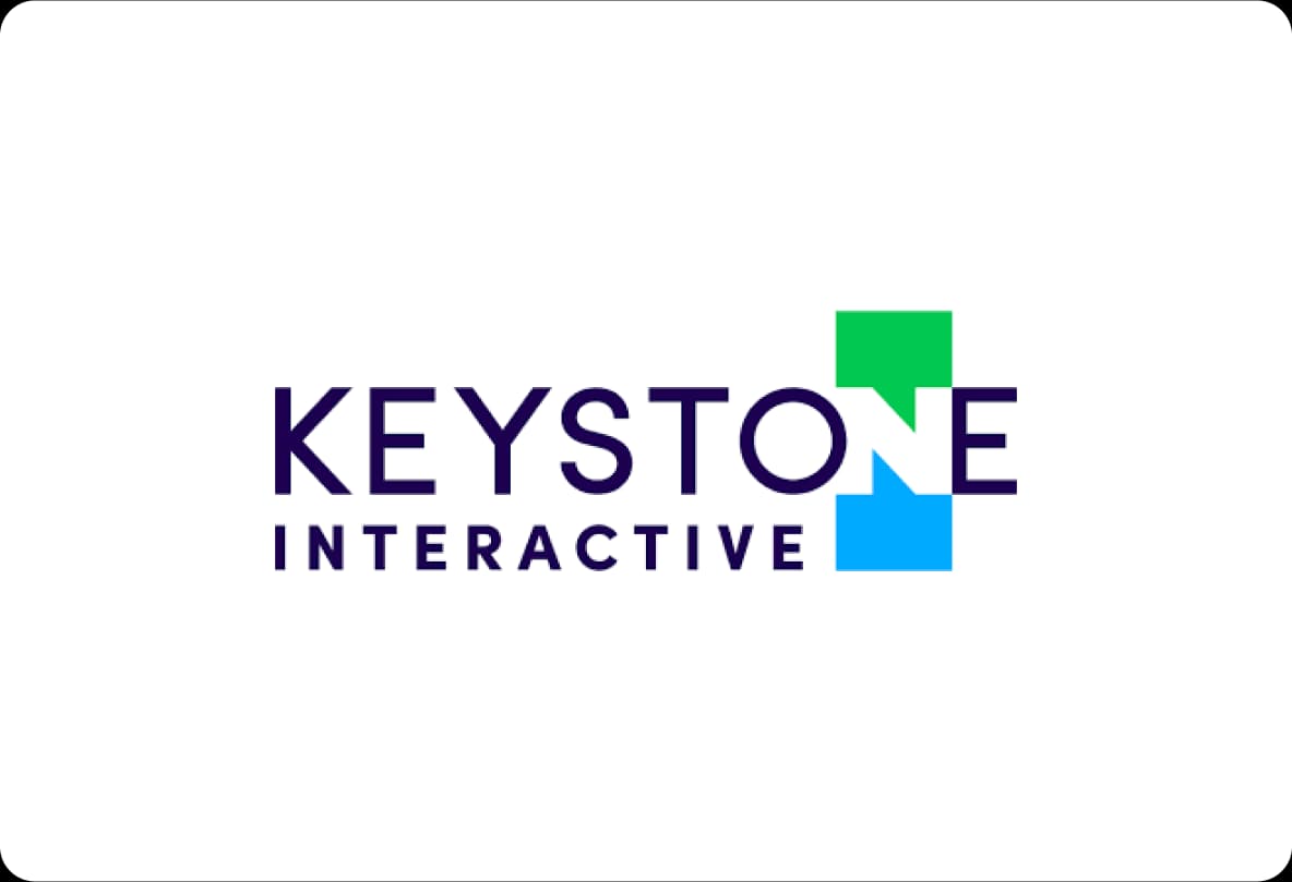 Logo of Keystone Interactive with the word "KEYSTONE" in navy blue, featuring green and blue geometric shapes forming the letter "N."