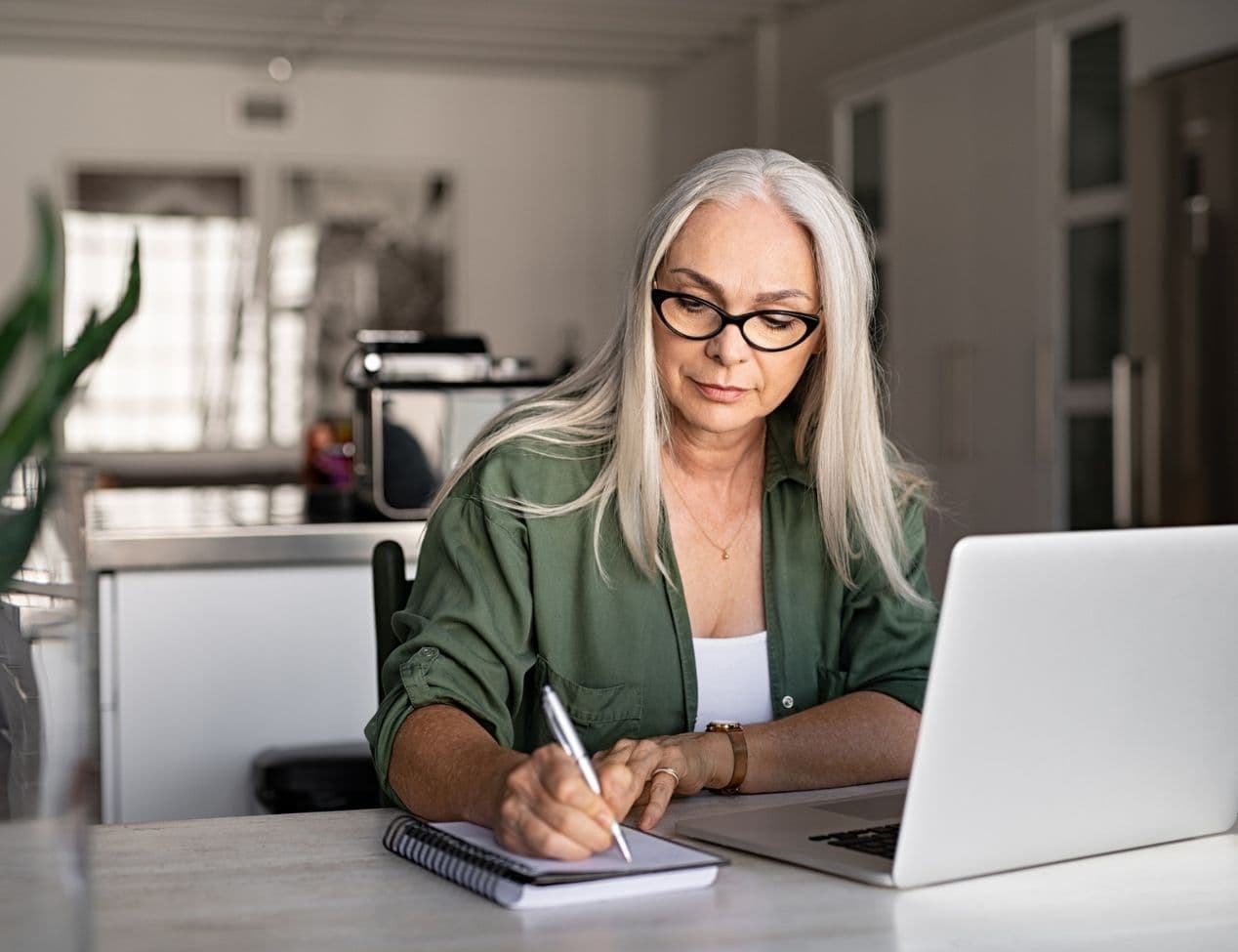 Woman writing down on notepad