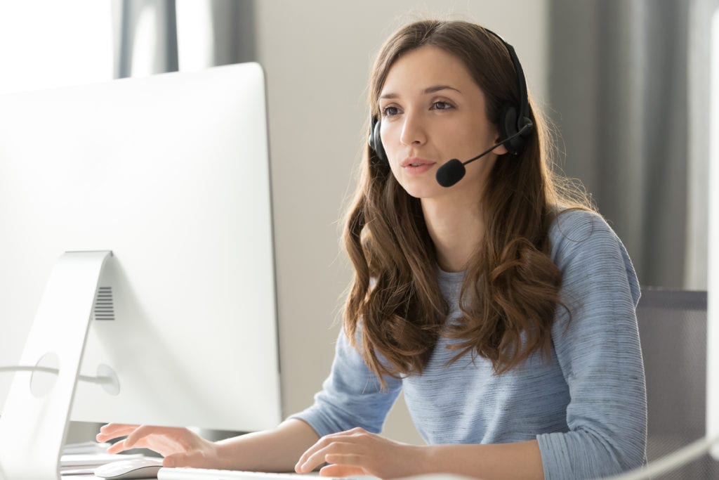 Young businesswoman in wireless headset call center agent -telemarketer